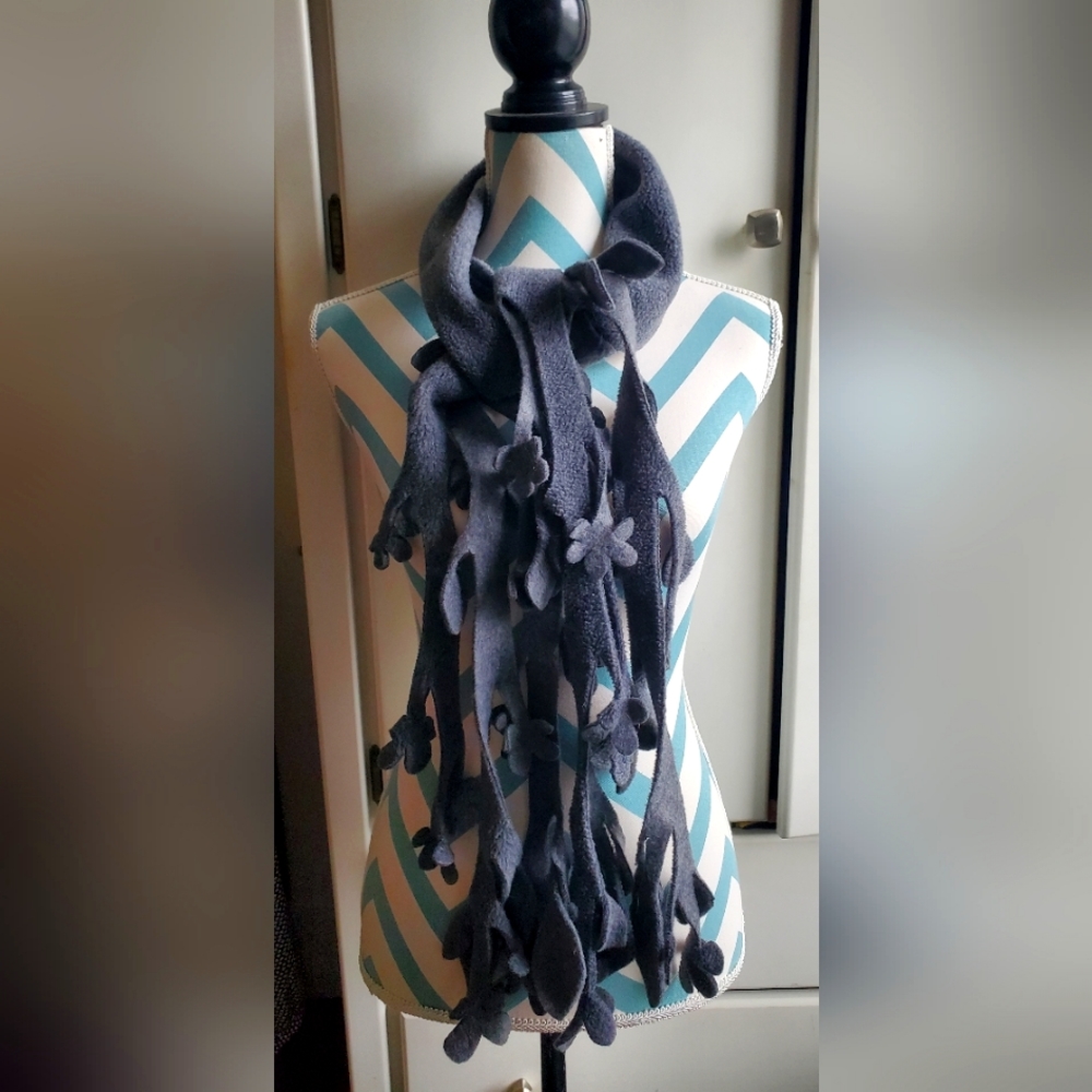 Gray fleecy scarf with cascading floral cutouts.
